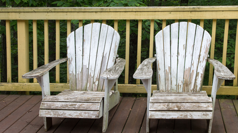 Worn out wooden porch chairs sitting on a deck