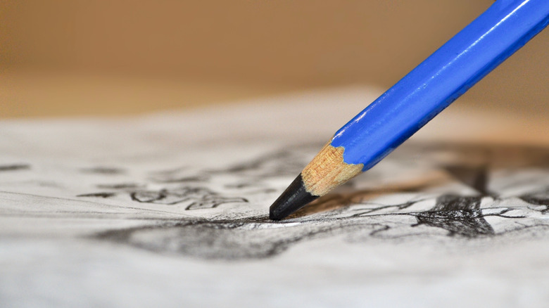 Close-up of pencil on graphite paper