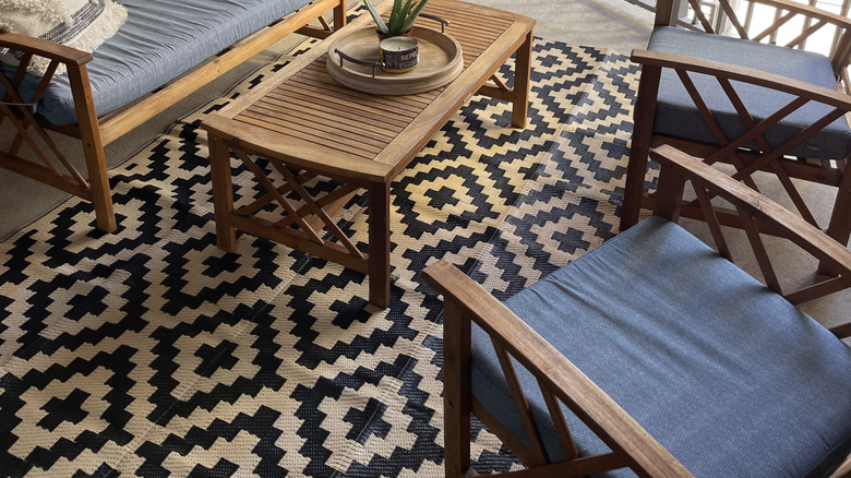 Small patio space with furniture and patterned rug