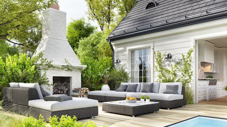 Outdoor patio with white and black sofas and table