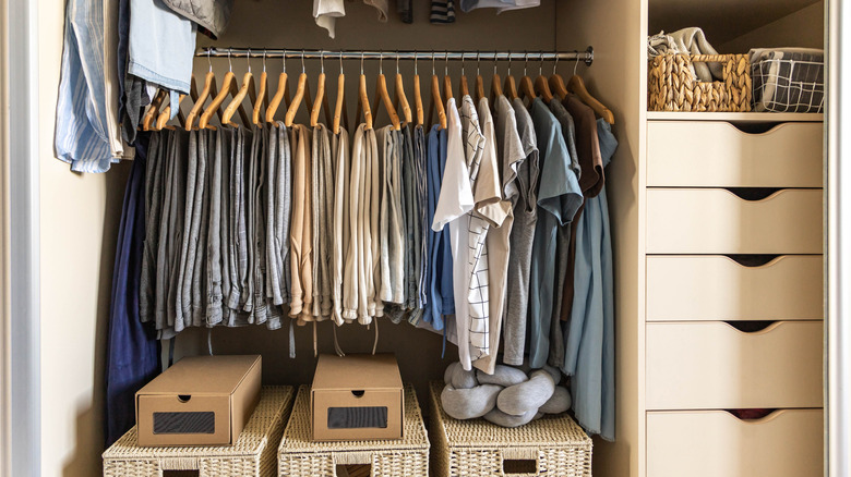 A neatly organized closet showcases decluttering and tidiness, with folded apparel, socks, and shirts neatly stored, leaving clean, open space.