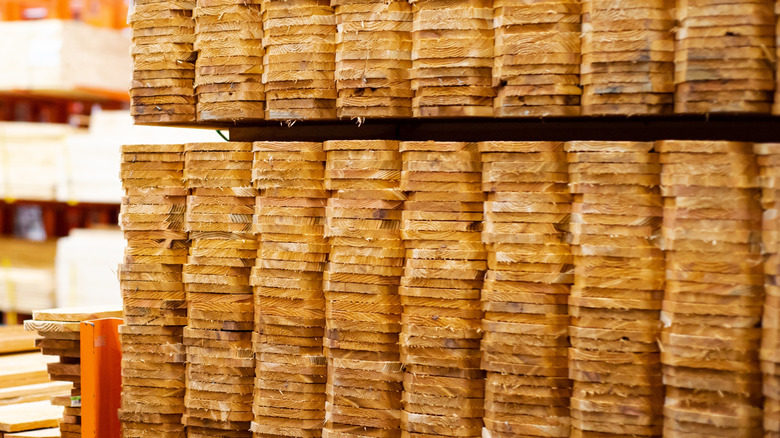 Pile of dog-eared fence panels at a lumber yard
