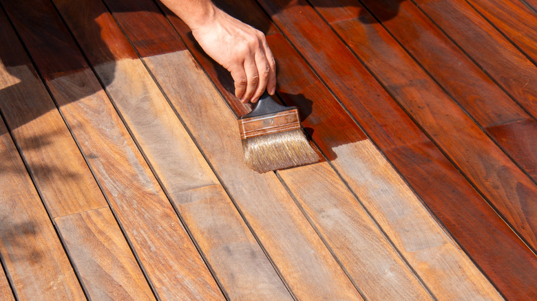 A person staining a deck