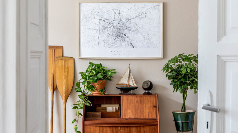 framed map and potted plants