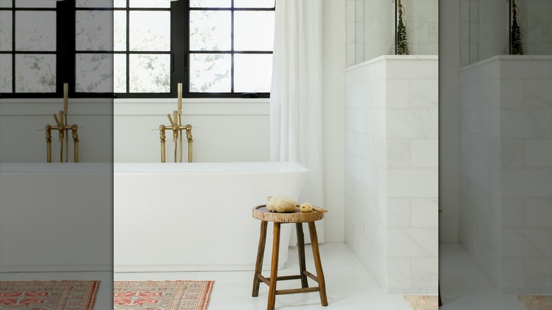 An antique stool in a white bathroom