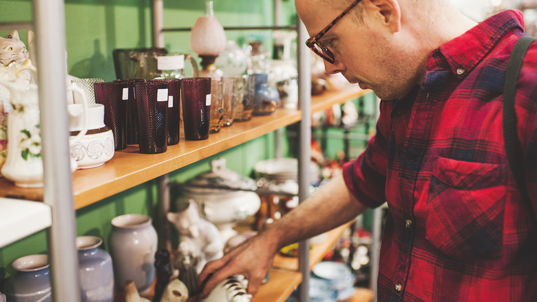 Person shopping for home decor at a thrift store