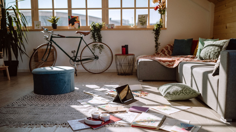 Cozy home with clutter, blankets, cushions, and plants