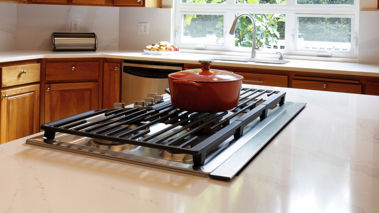 Kitchen island stovetop with built-in downdraft vent