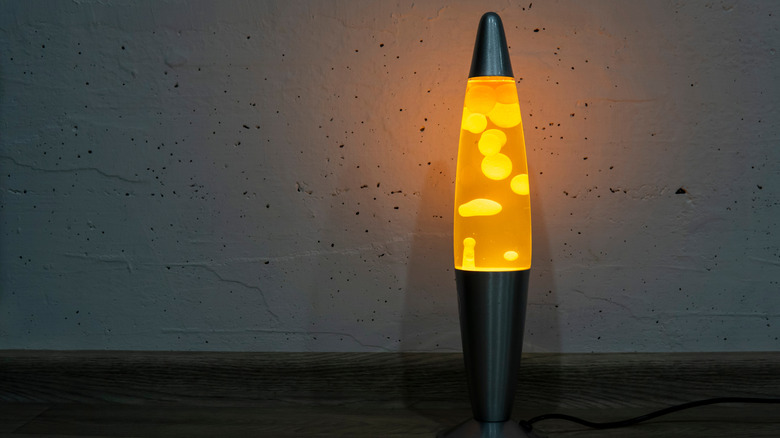An orange lava lamp glowing in a dimly-lit room