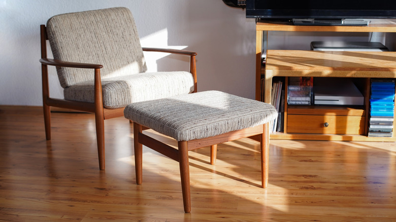 A mid-century Scandi-style armchair and foot stool