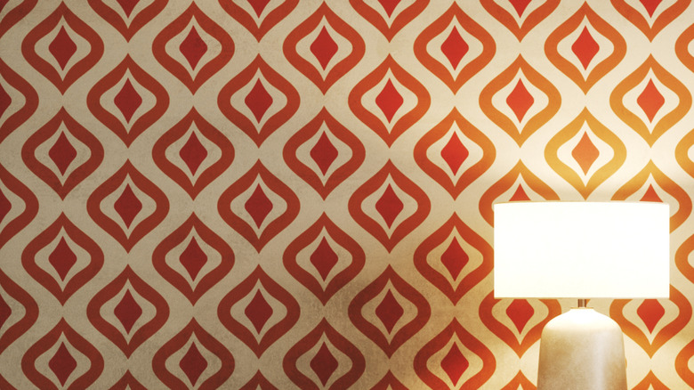 A vintage living room setting with vibrant patterned wallpaper