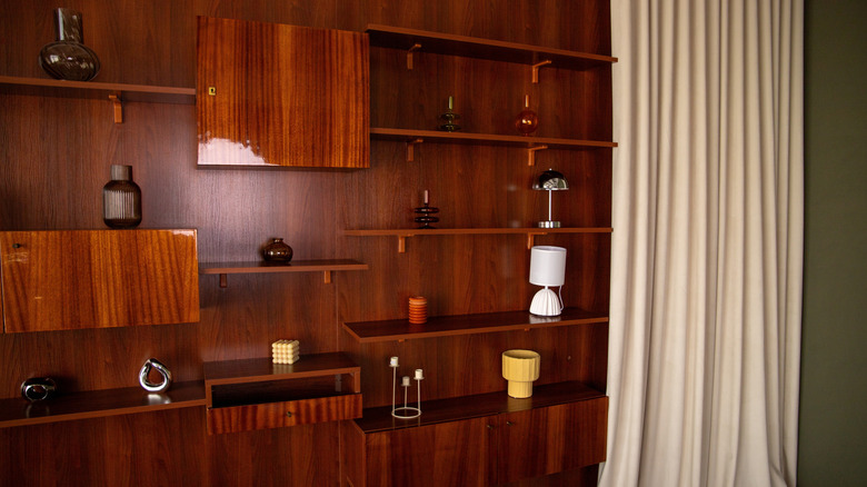 A vintage mid-century living room with wood-panelled wall