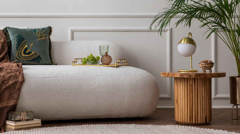 White boucle couch with fluted side table