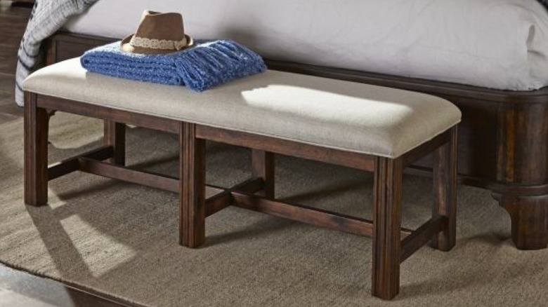 Bench at the edge of a bed.