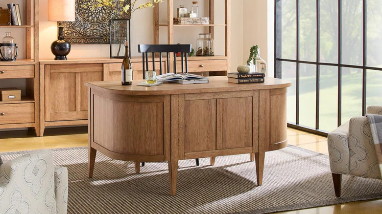 A black desk with drawers.