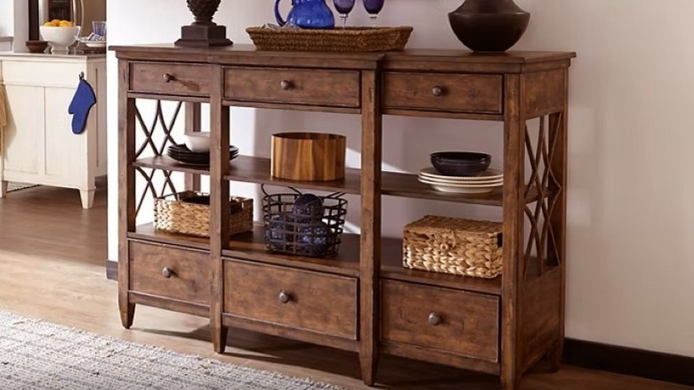 Wooden buffet with items on it.