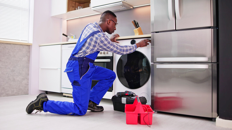 Repairman working on washing machine
