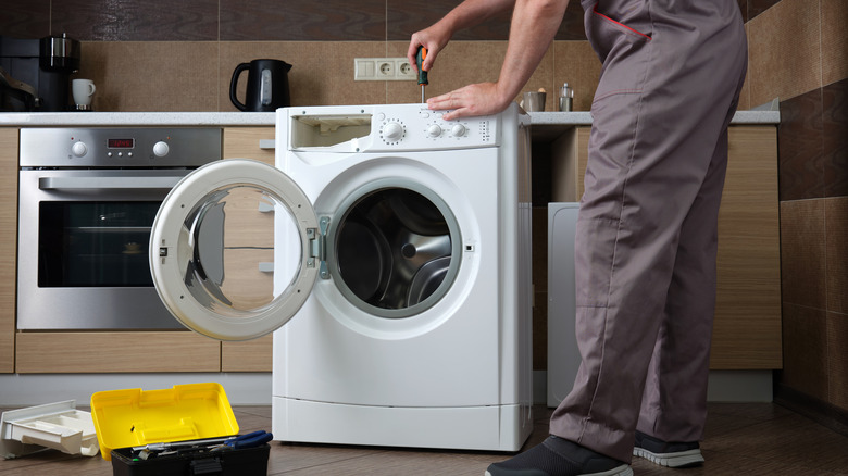 Technician working on washing machine