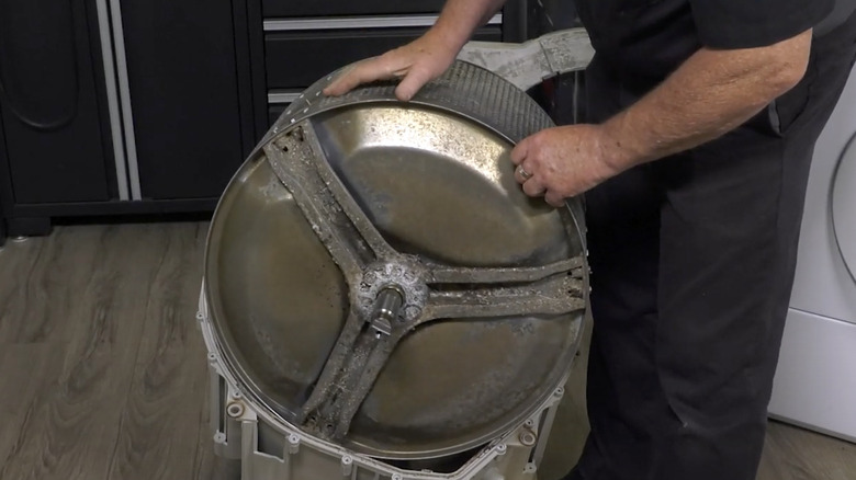 Washing machine spider held by person