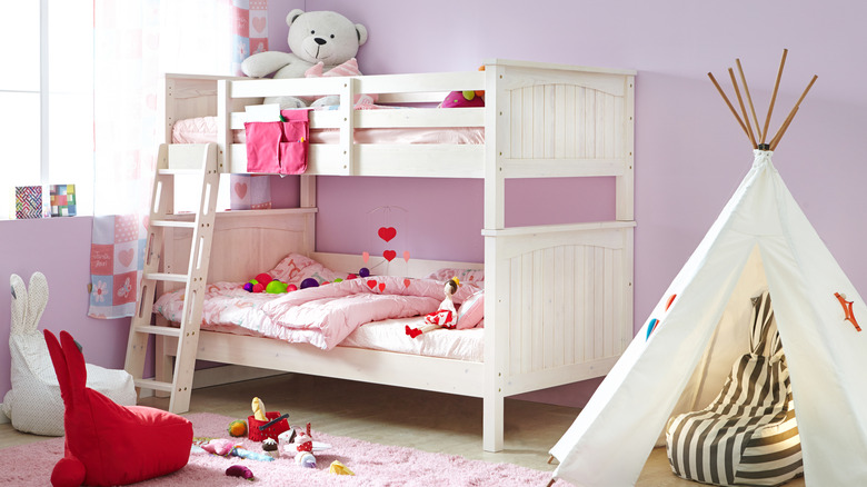White bunk bed with pink bedding