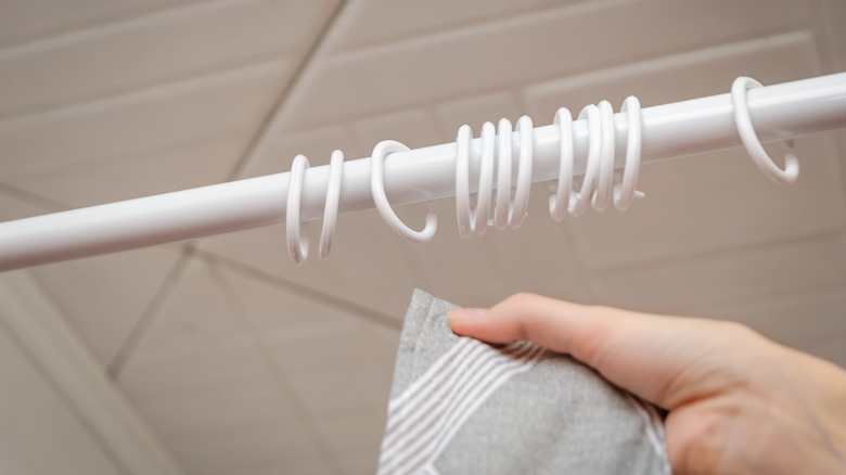 Close up of shower curtain rings on white rod