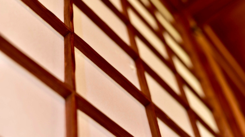 A typical example of Japanese-style shoji screen is shown in warm hues of oak and cream.