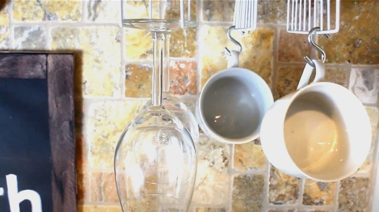 mugs and wine glass hanging on Dollar Tree shower caddy