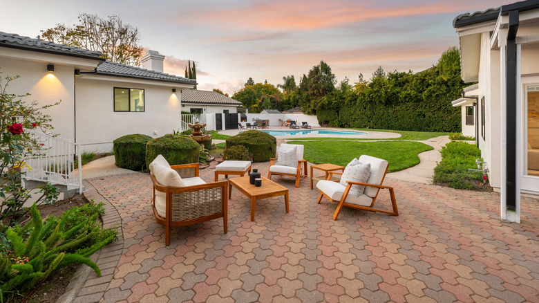 A patio with chairs at sunset