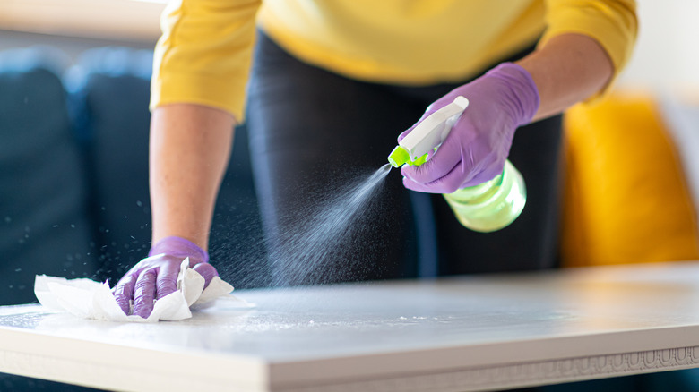 Spraying and wiping down countertop