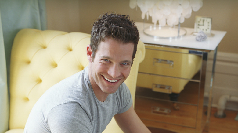Nate Berkus with a yellow chair behind him.