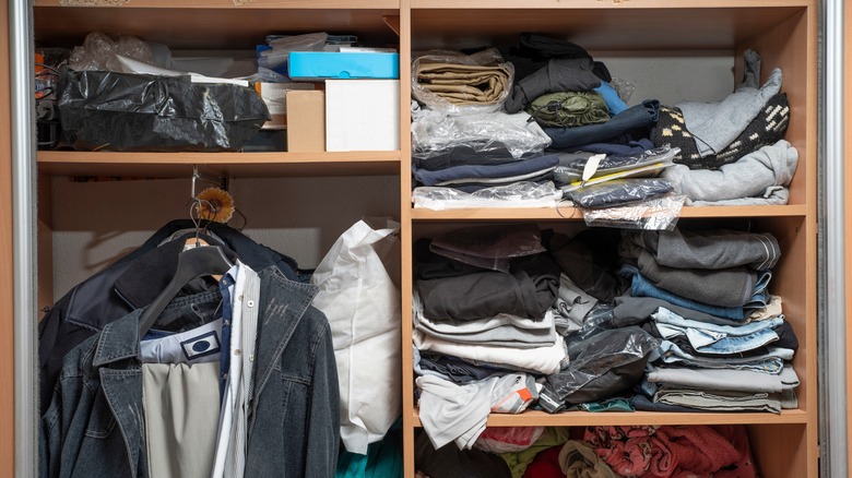 Cluttered closet with clothes