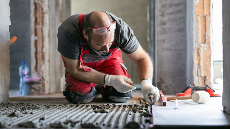 man installing tile
