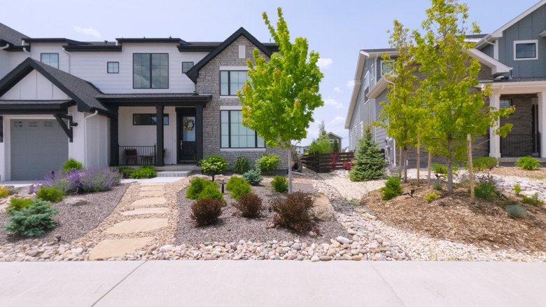 Home with stone mulch around shrubs and trees