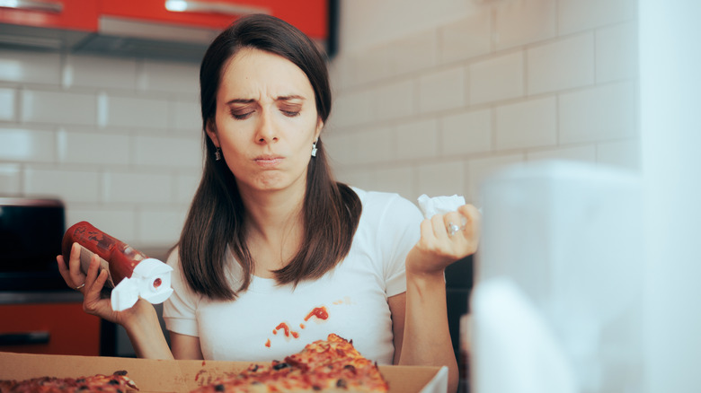 Woman has tomato stain on shirt