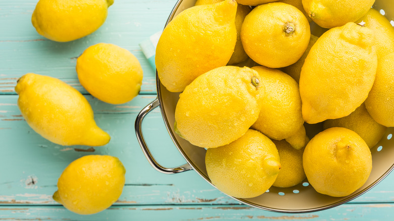 colander of lemons on table 