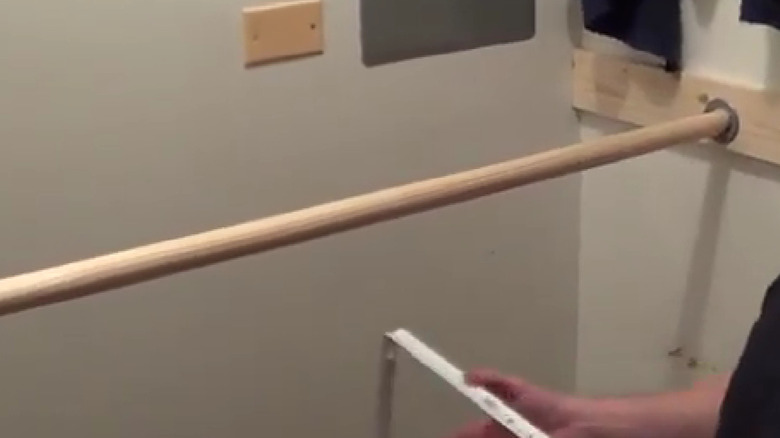 Wooden rod mounted low in a closet