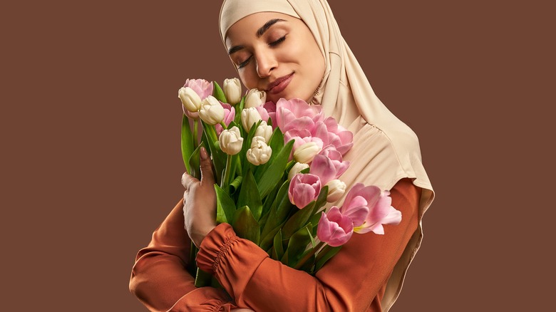 Person hugging tulips
