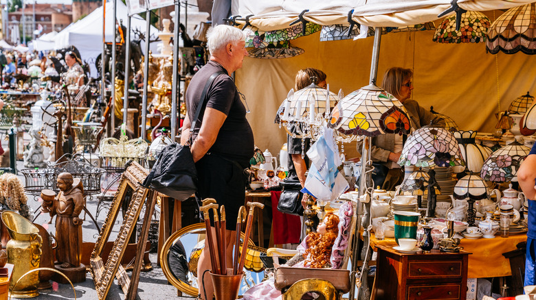 People shopping at an outdoor flea market.