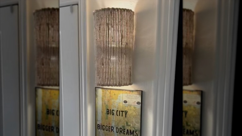 Closeup of the wall sconce hanging up with the lights turned on