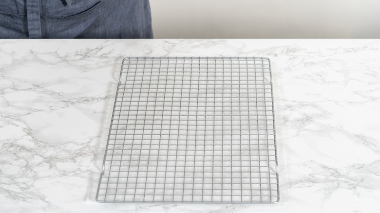 An empty cooling rack on a marble surface