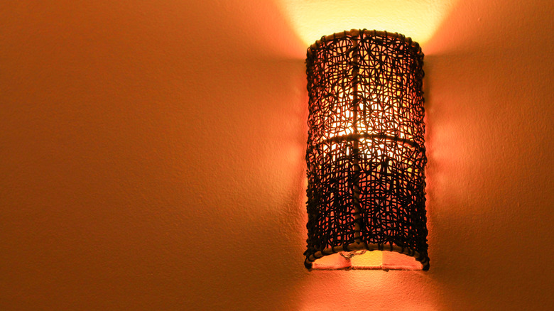 A cylindrical wall sconce made of natural materials