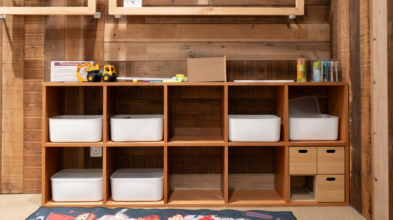 Cube storage shelf with bins in a room