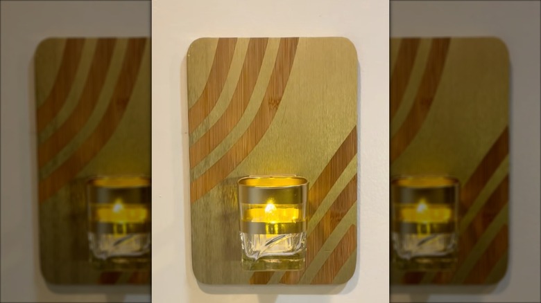 A DIY wall sconce made with supplies from the Dollar Tree