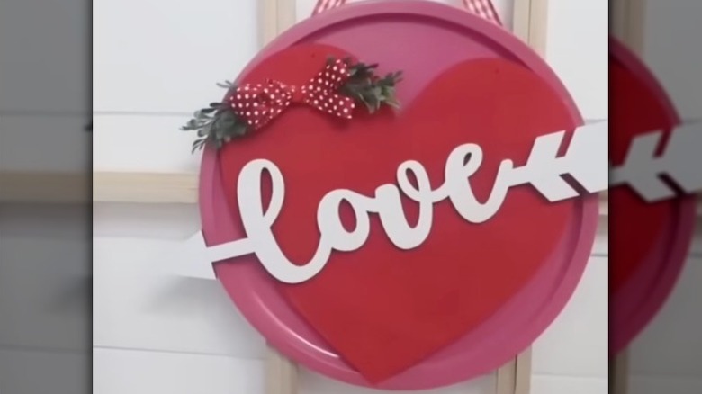 A Valentine's Day sign mounted on a ribbon