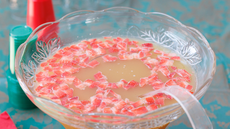 A punch bowl filled with strawberries and punch