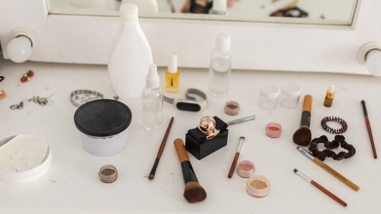 Makeup scattered across a bathroom counter.