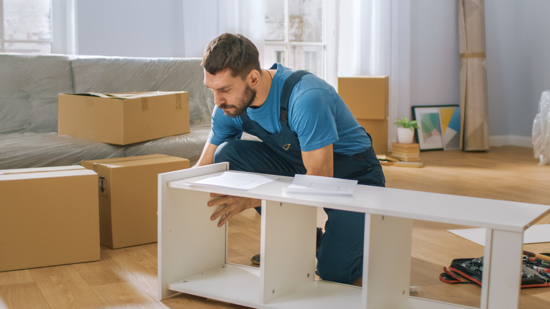 man building cabinet