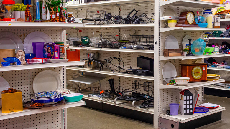 Thrift store shelves hold many items from kitchen goods to metal organizing supplies that could be repurposed as planters.