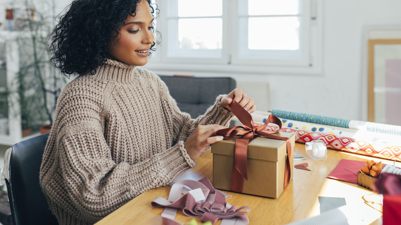 woman wrapping gift box