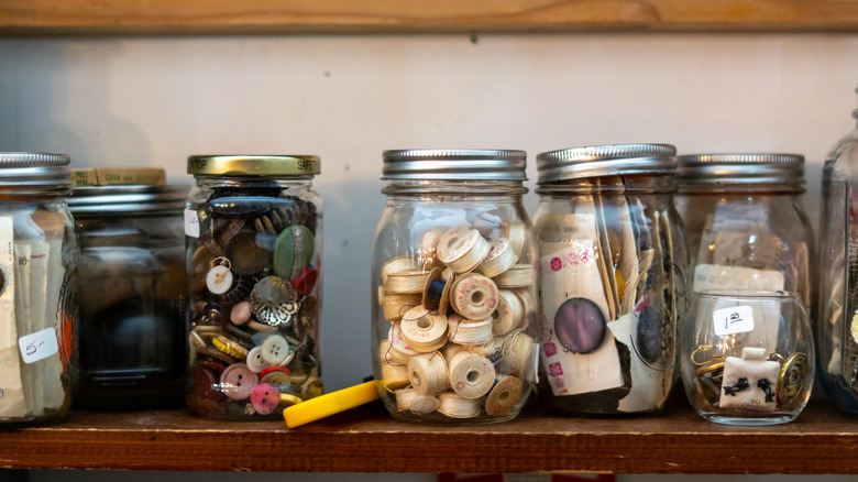 Mason jars on a shelf filled with various items